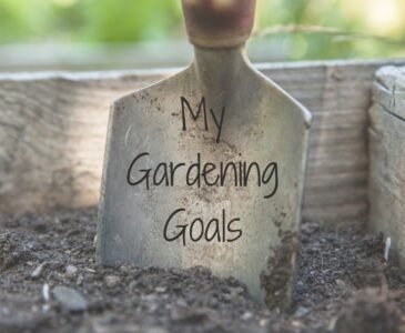 Photo of a garden spade in soil in a raised bed. Text over the spade reads: My Gardening Goals