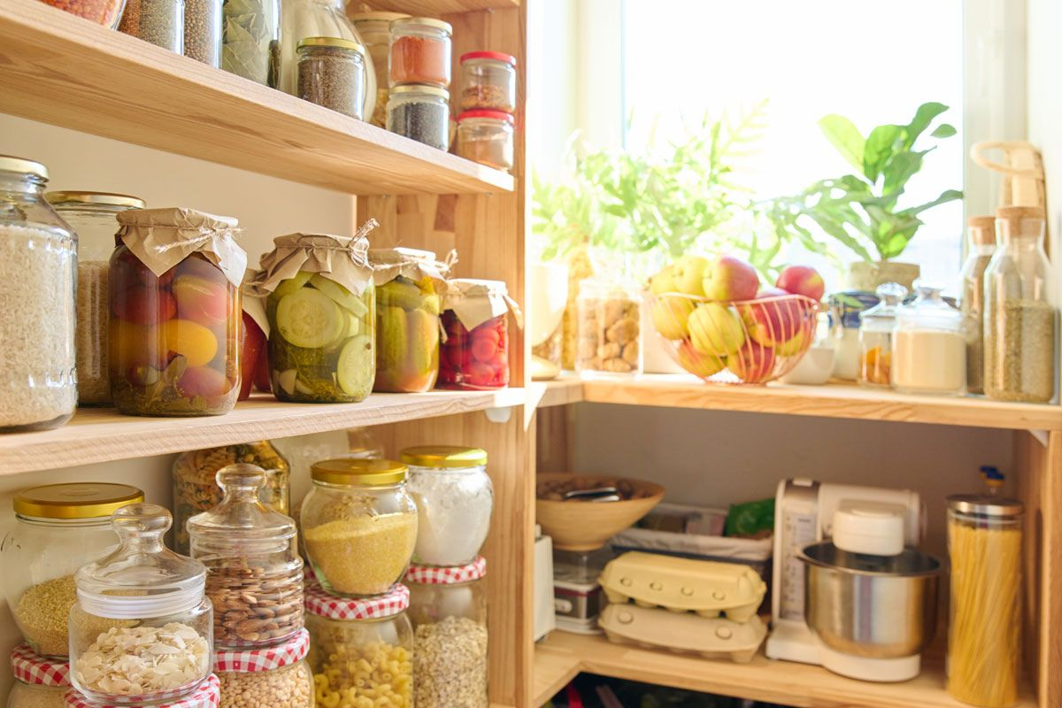 Photo of pantry shelves with canned goods and kitchenn tools.