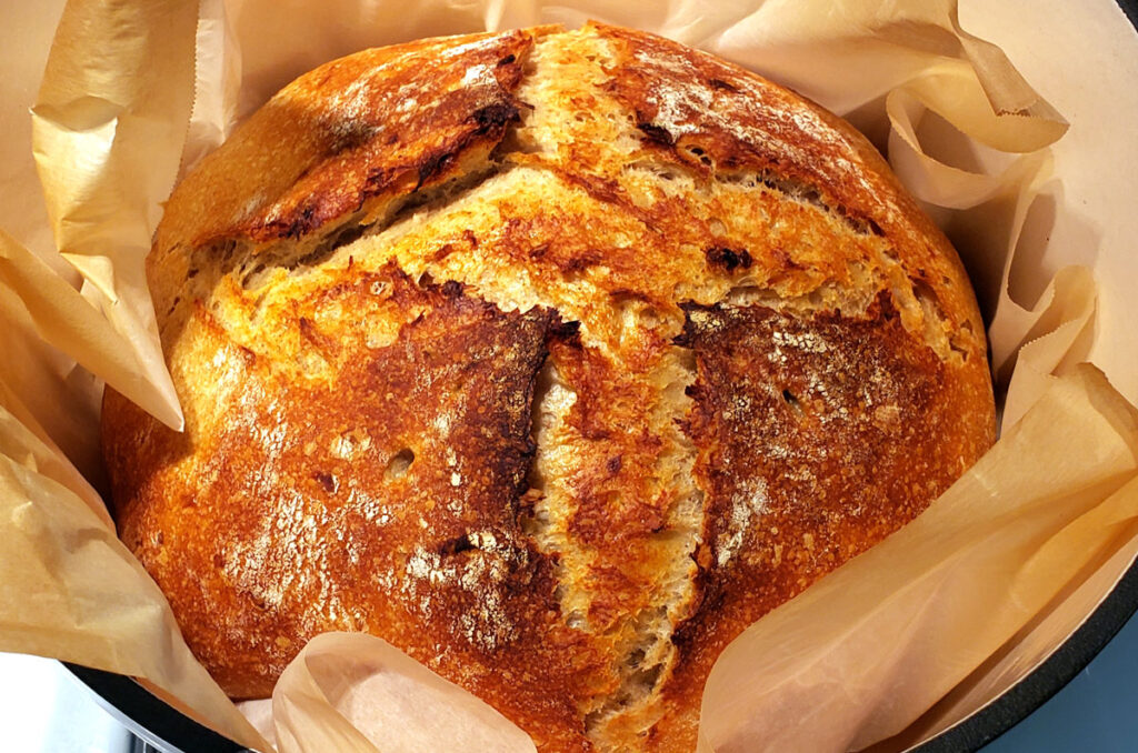 baked sourdough bread in a dutch oven