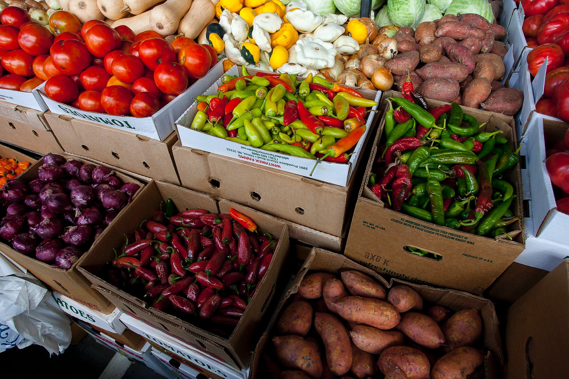 sweet potatoes chillis and onions on box