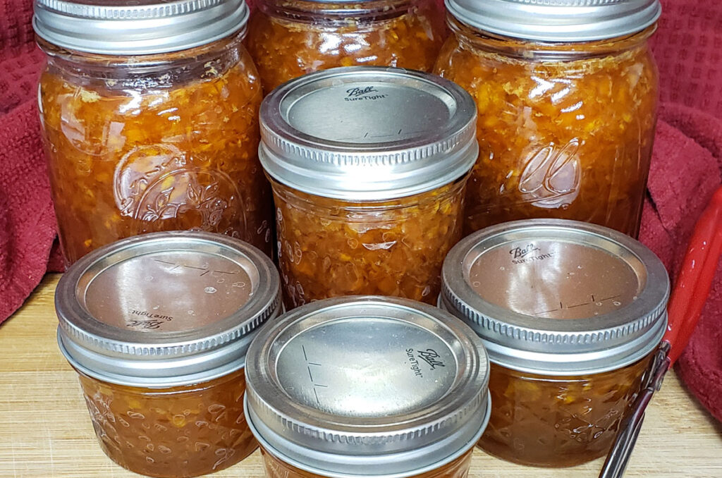 Pint and half pint jars of canned loquat jam.