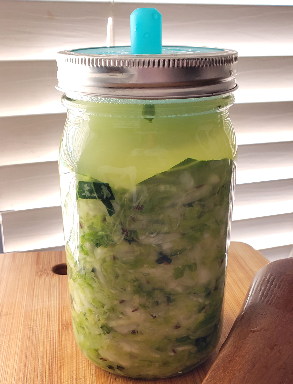 Quart jar of fermenting cabbage.