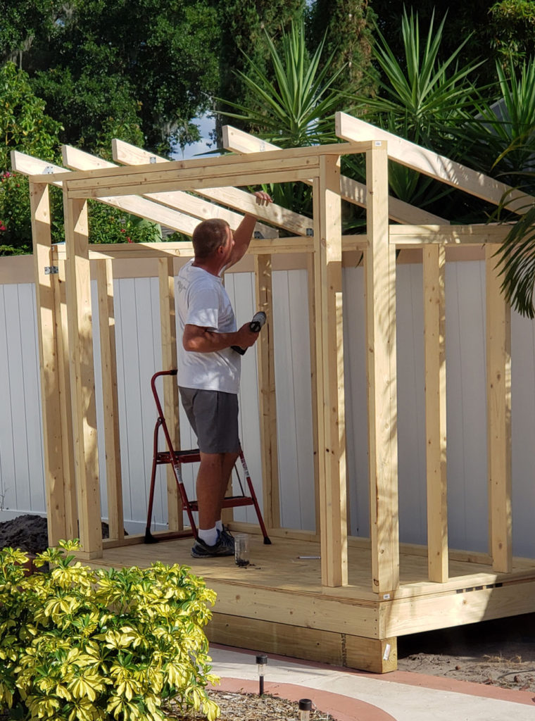 person building a garden shed