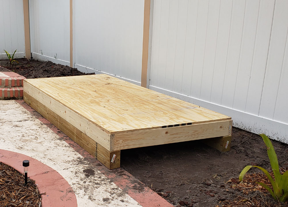 shed floor against fence