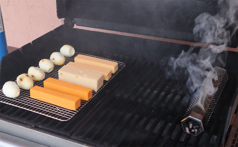 cheese and hard boiled eggs smoking on a grill