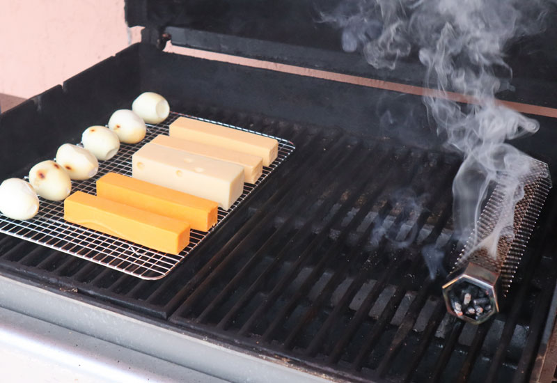 cheese and hard-boiled eggs smoking on grill