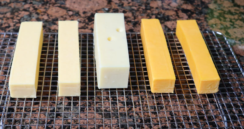 gruyere swiss cheddar cheese blocks before smoking