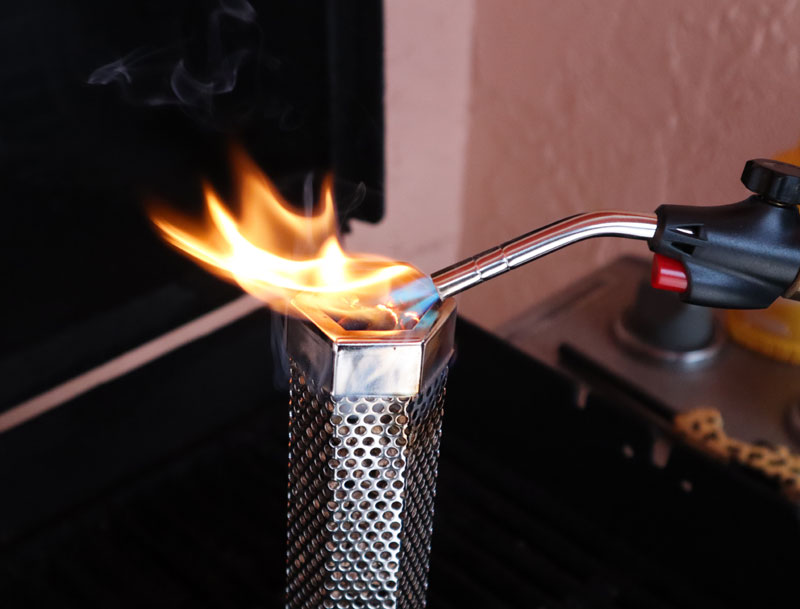 torch lighting a smoke pellet tube