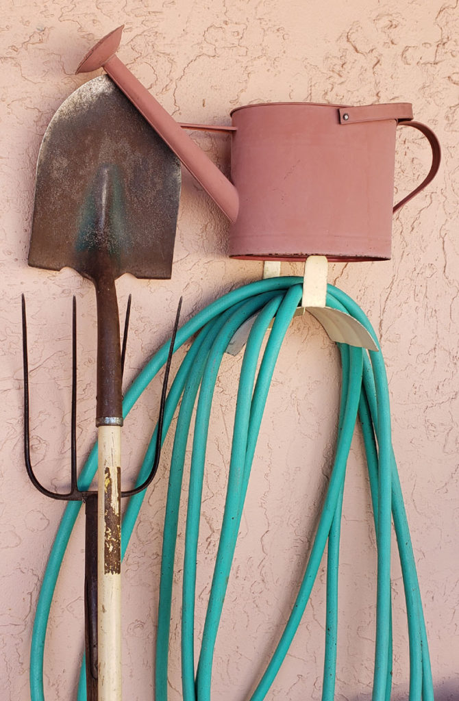 shovel, pitchfork, watering can, garden hose