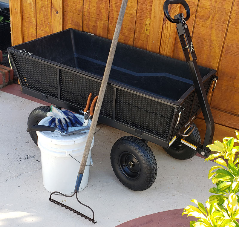 6 garden tools leaning against a shed