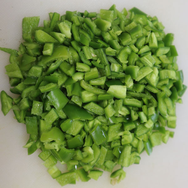 chopped peppers on a white tray