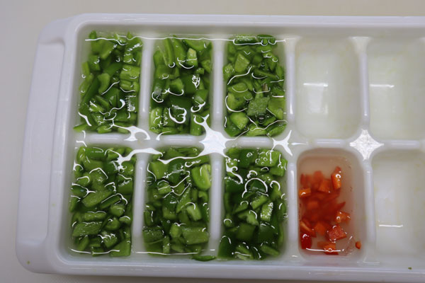 chopped jalapeno  peppers in ice cube tray