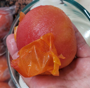 tomato skin slipping off a frozen tomato