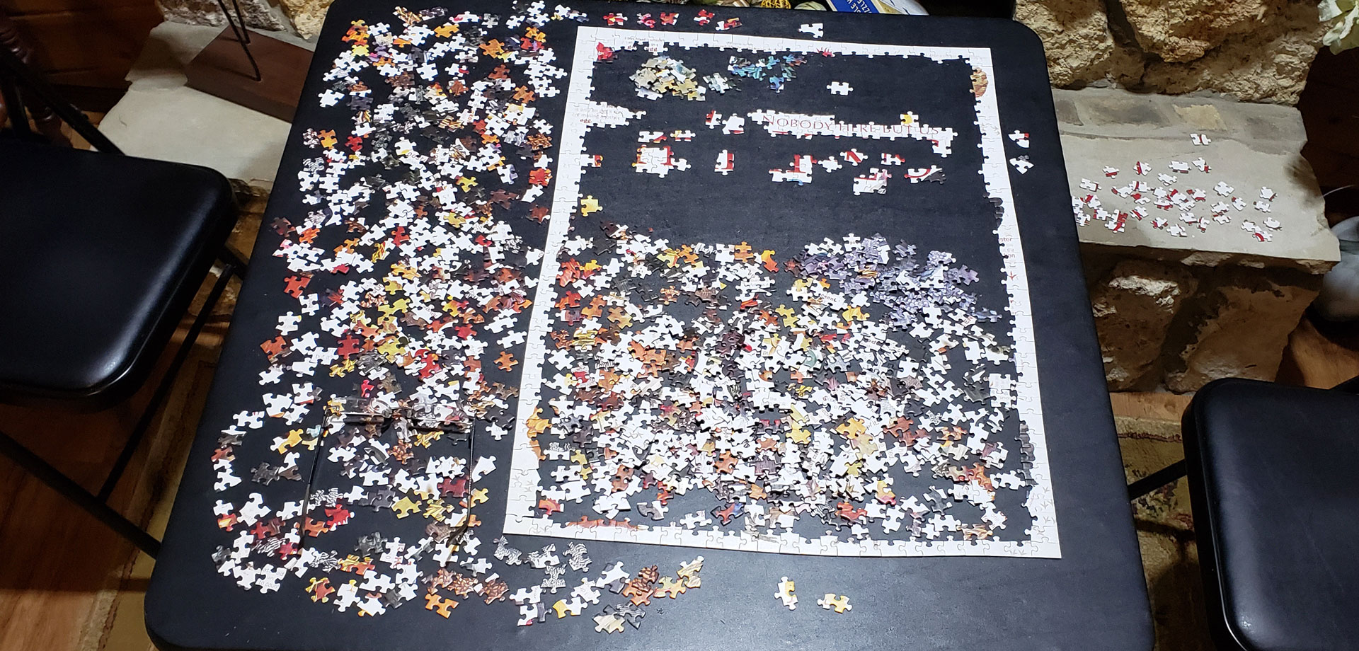 unfinished jigsaw puzzle on a card table