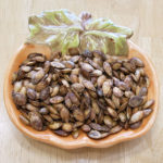 roasted pumpkin seeds in a pumpkin-shaped bowl