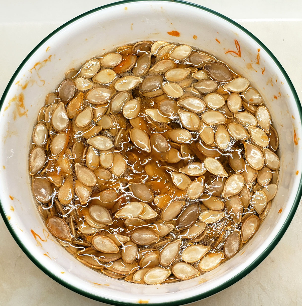 bowl with pumpkin seeds soaking in water.