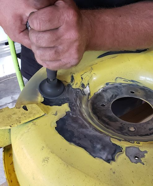 Mike cleaning old paint off a mower deck