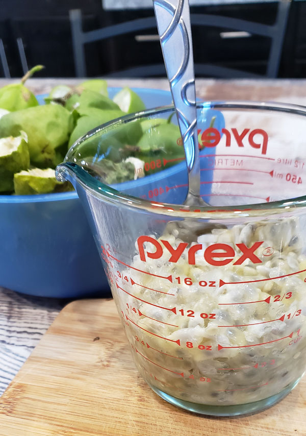 maypop fruit in a glass measuring cup to make jelly