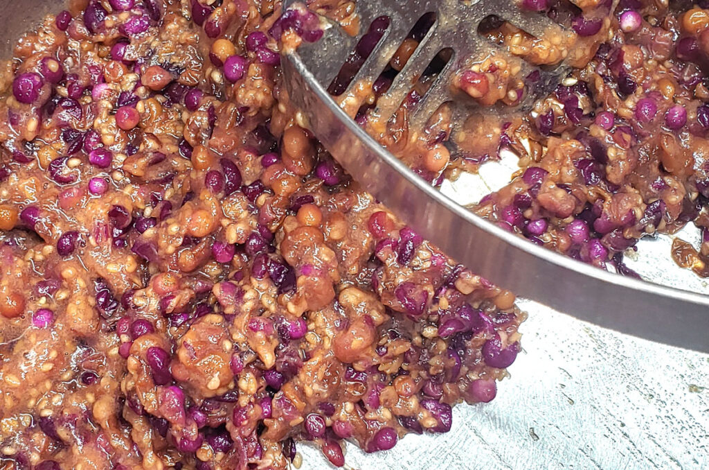 close-up view of mashed beautyberries in a pot.