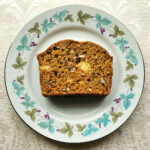 A slice of sweet potato bread on a decorative plate.