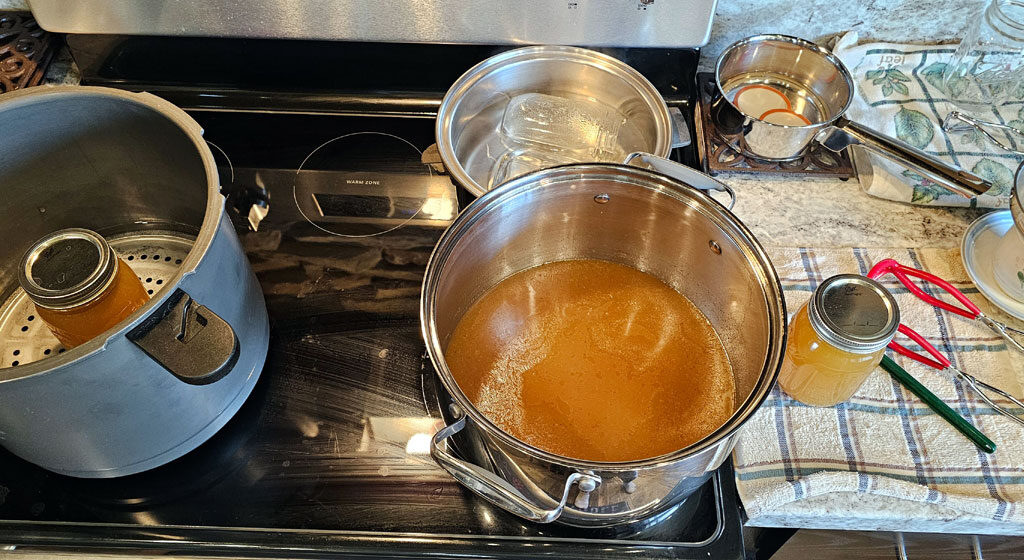 Glasstop stove and countertop with canning tools ready for canning.