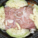 Photo of corned beef and cabbage in a crock pot just before cooking.