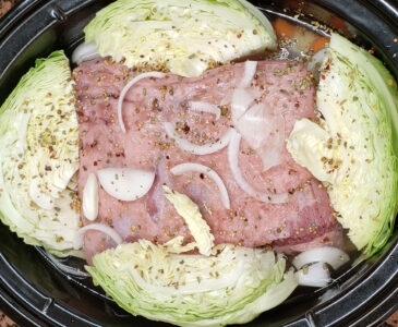 Photo of corned beef and cabbage in a crock pot just before cooking.