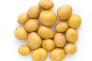 photo of fresh yellow potatoes on a white background.