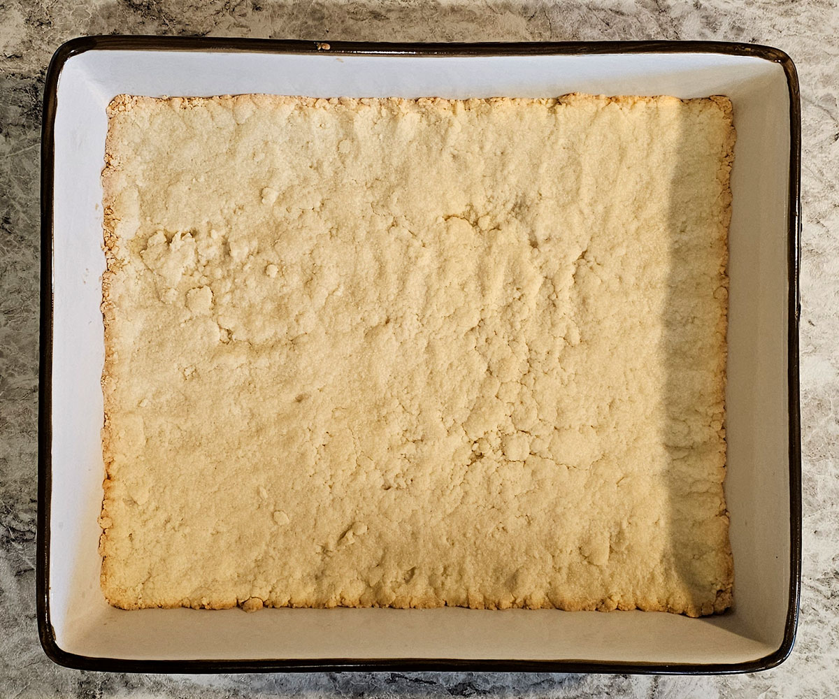 Overhead view of baked crust in glazed ceramic 9x13x2 baking pan.