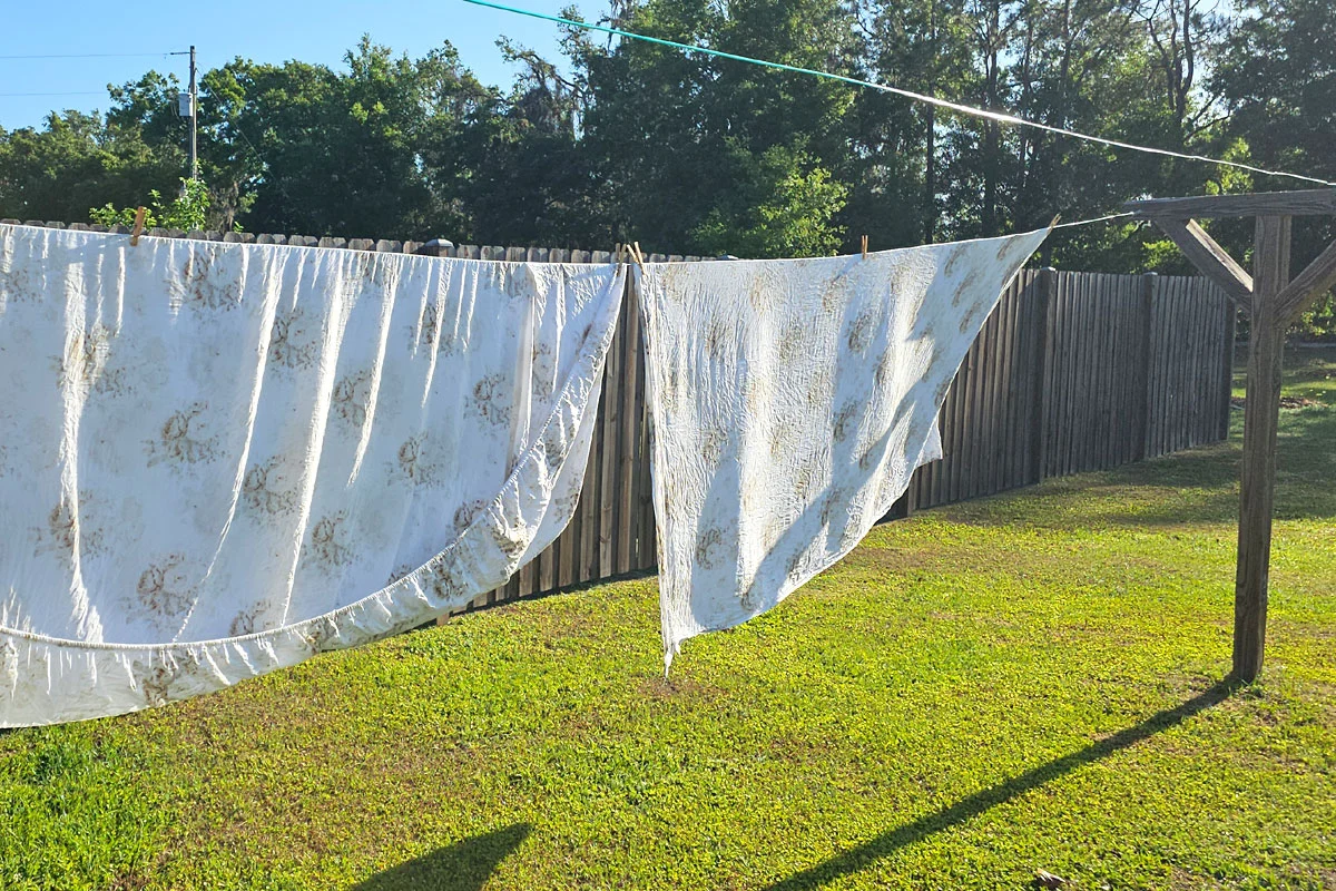 sheets on a clothesline on a sunny, breezy day.