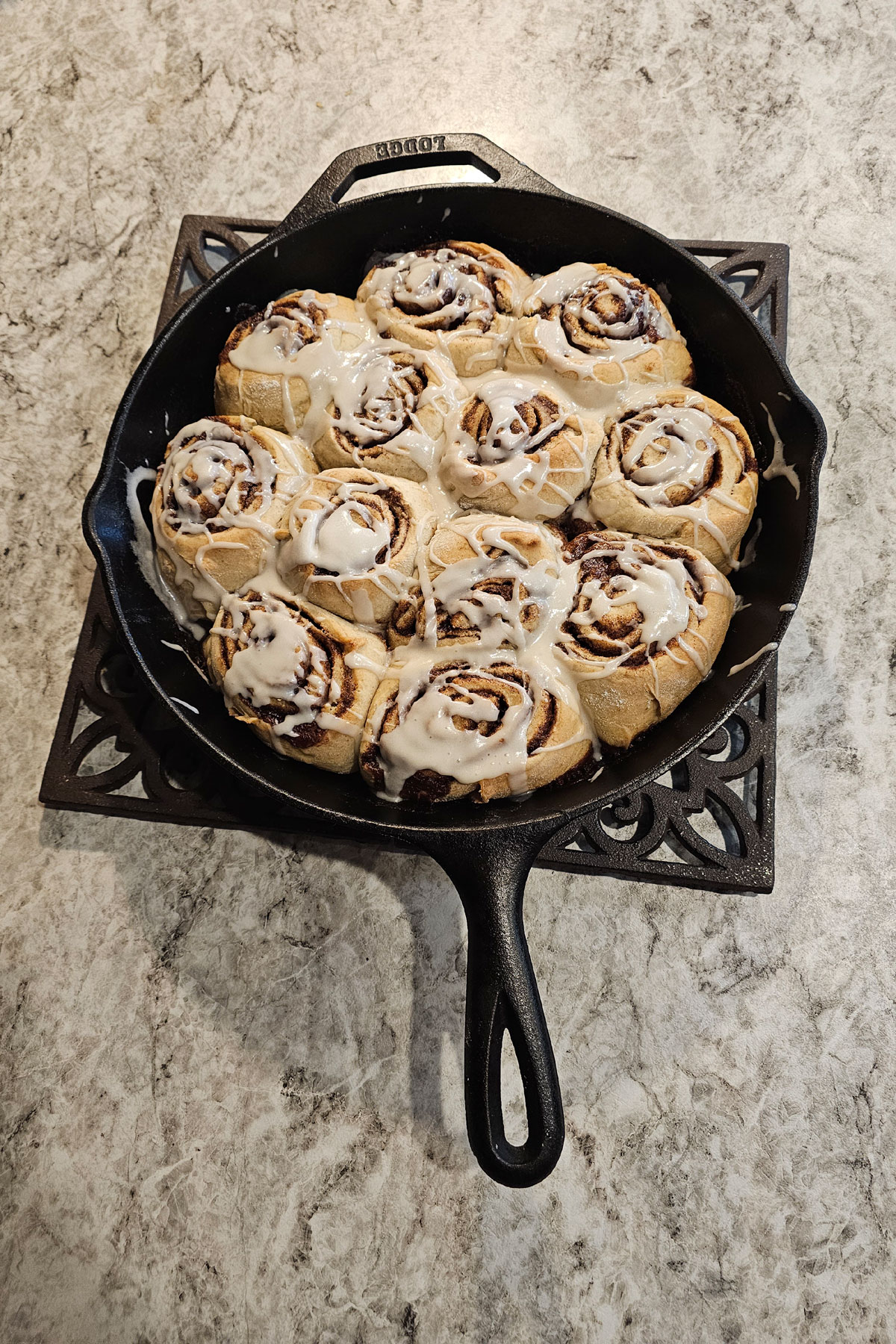 Sourdough discard cinnamon rolls baked in a cast iron frying pan.